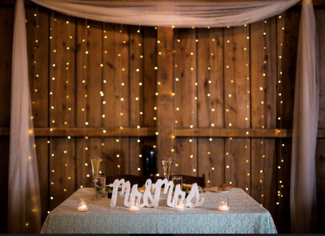Curtain of Lights Behind Sweetheart Table
